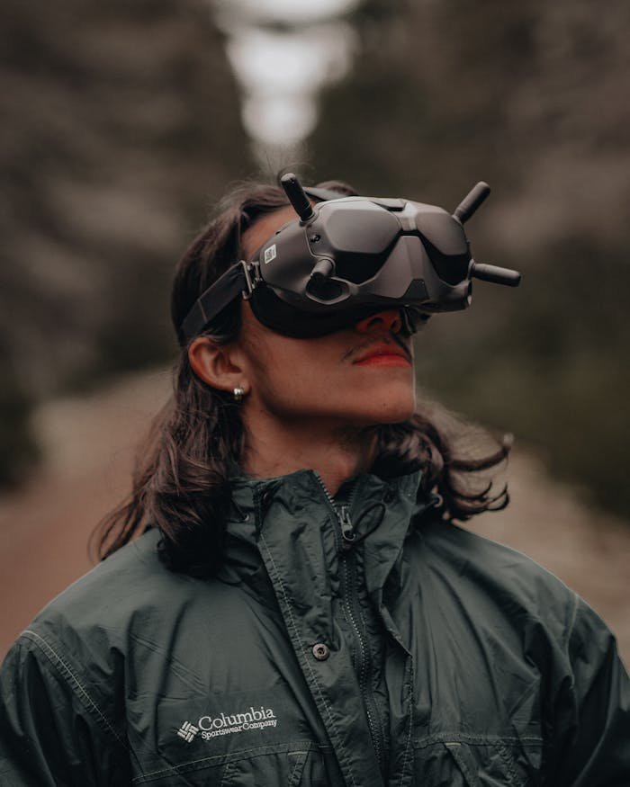 Services A person wearing FPV goggles enjoys the forest outdoors, showcasing adventure and technology.